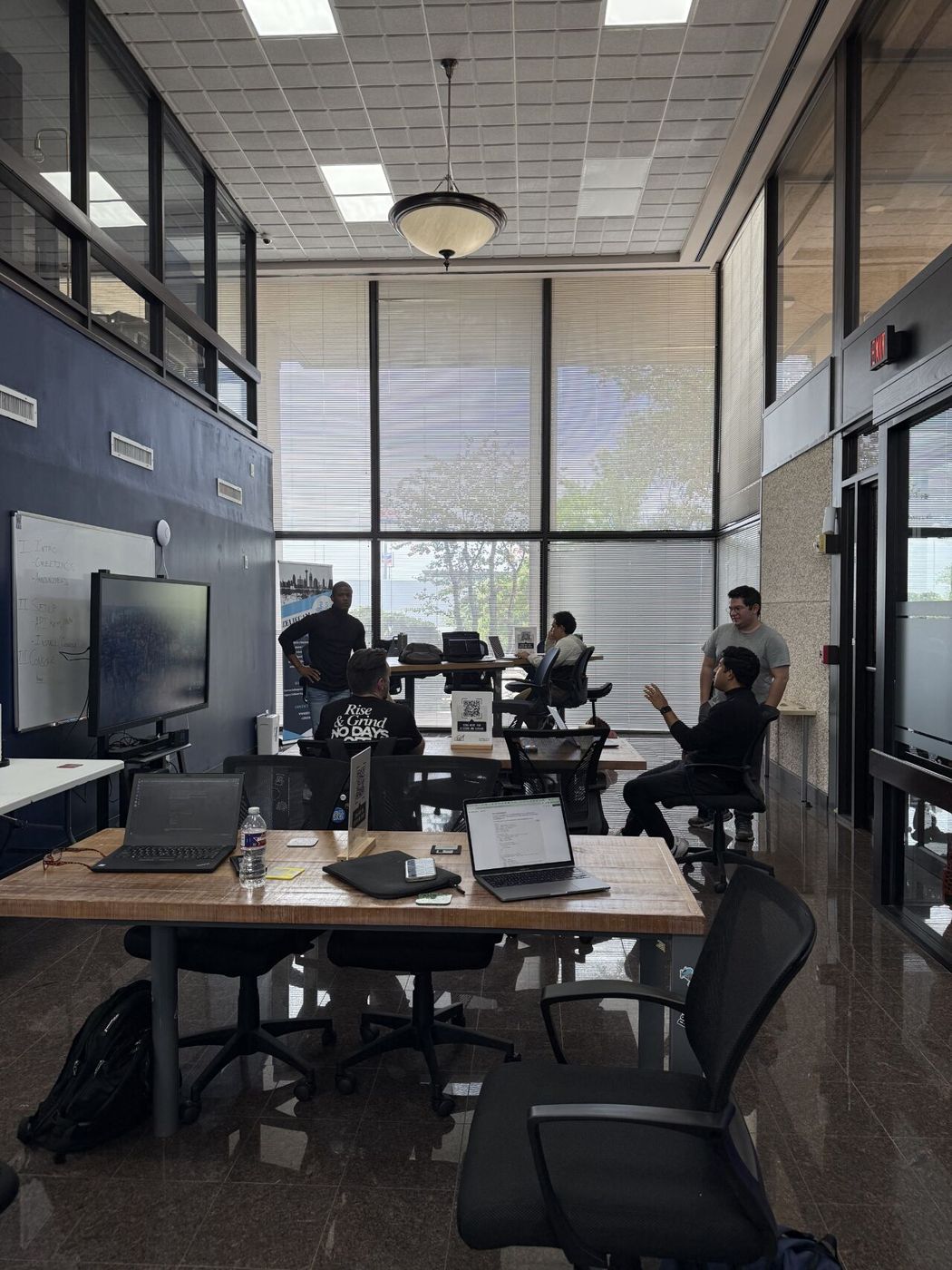Developers working on laptops at an AI meetup