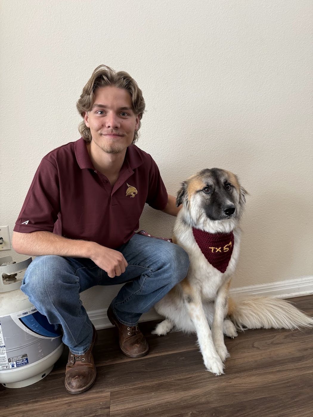 Brian in a Texas State polo with his dog Monty